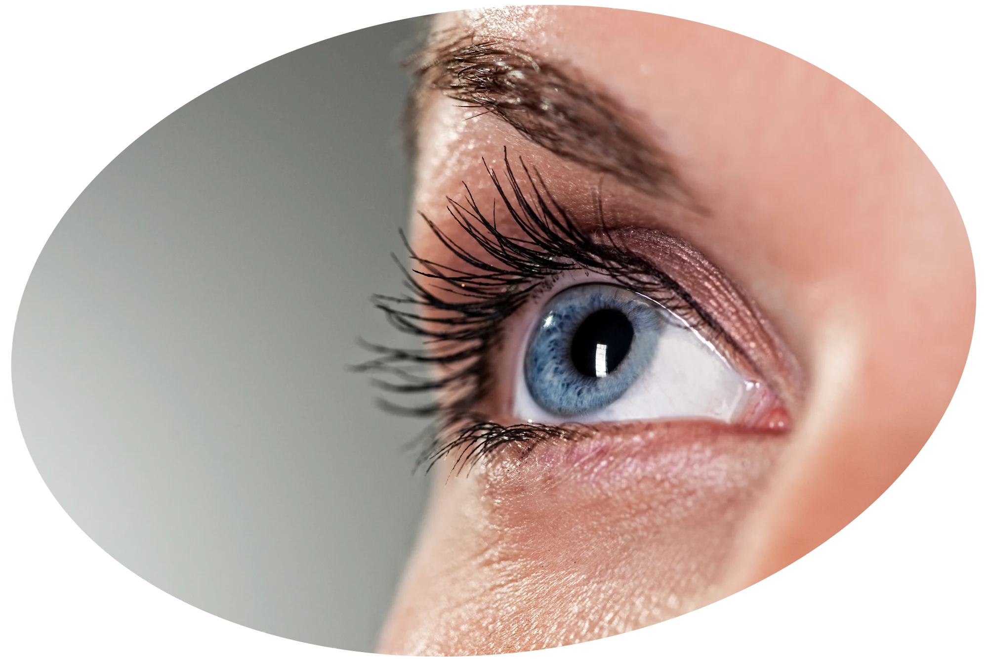 Close up photo of a woman's eye with a blue iris.