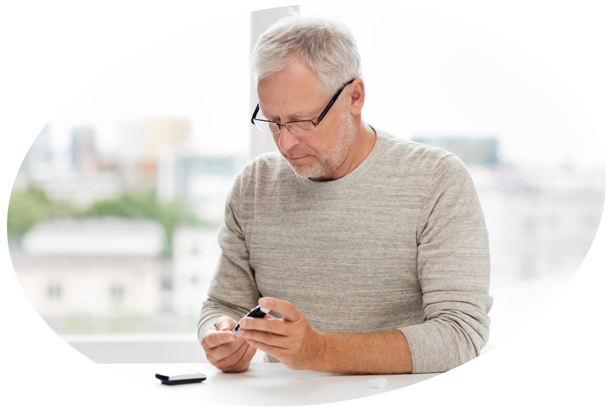 Photo of a man pricking his finger with a blood sugar monitor.
